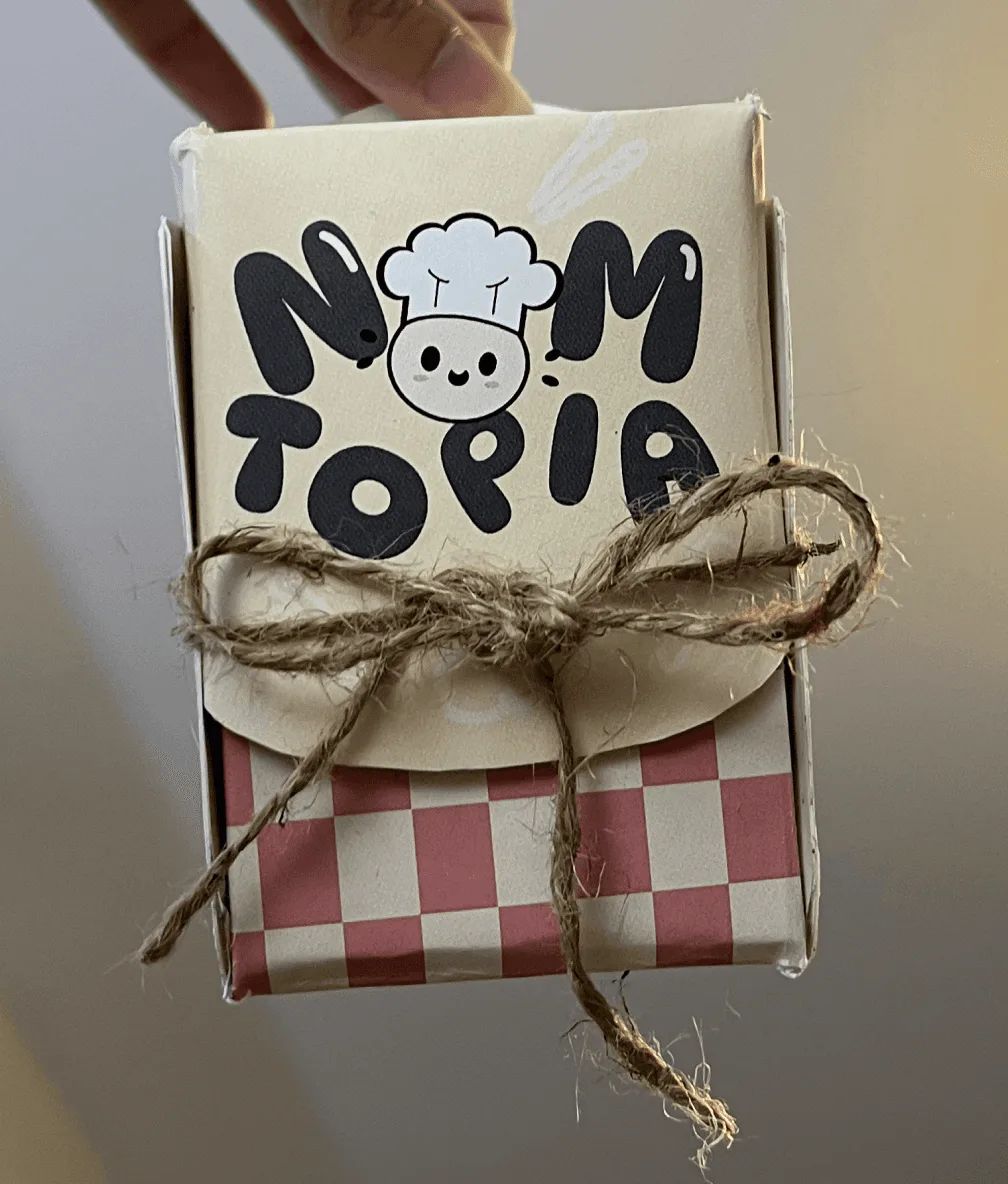Printed Nomtopia blind box tied with twine