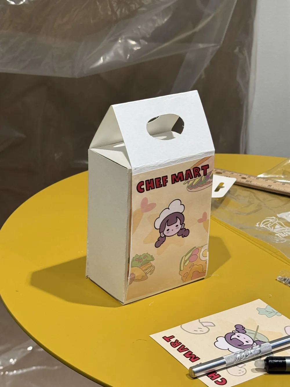 Paper mockup of the Nomtopia box