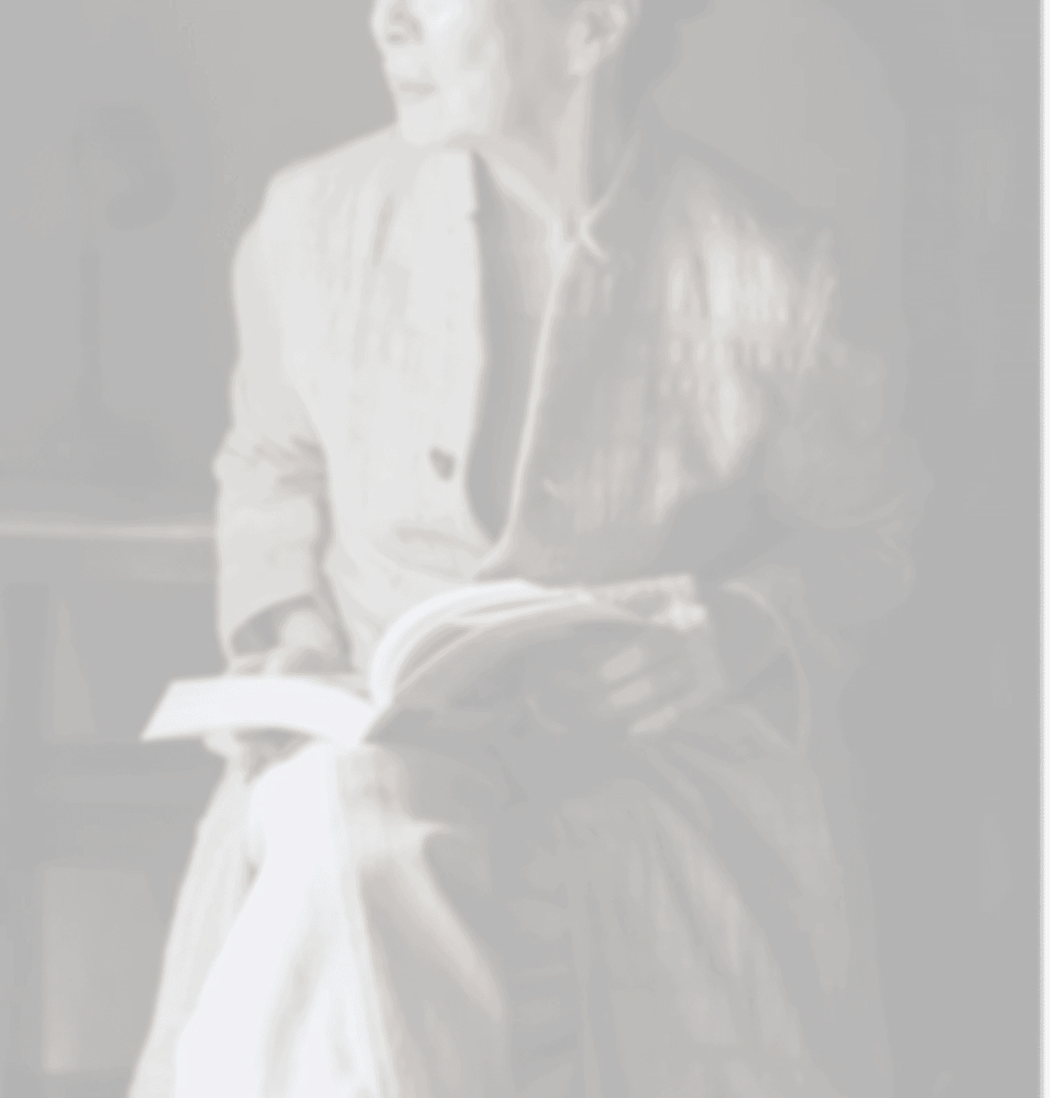 An older woman reading quietly in a chair
